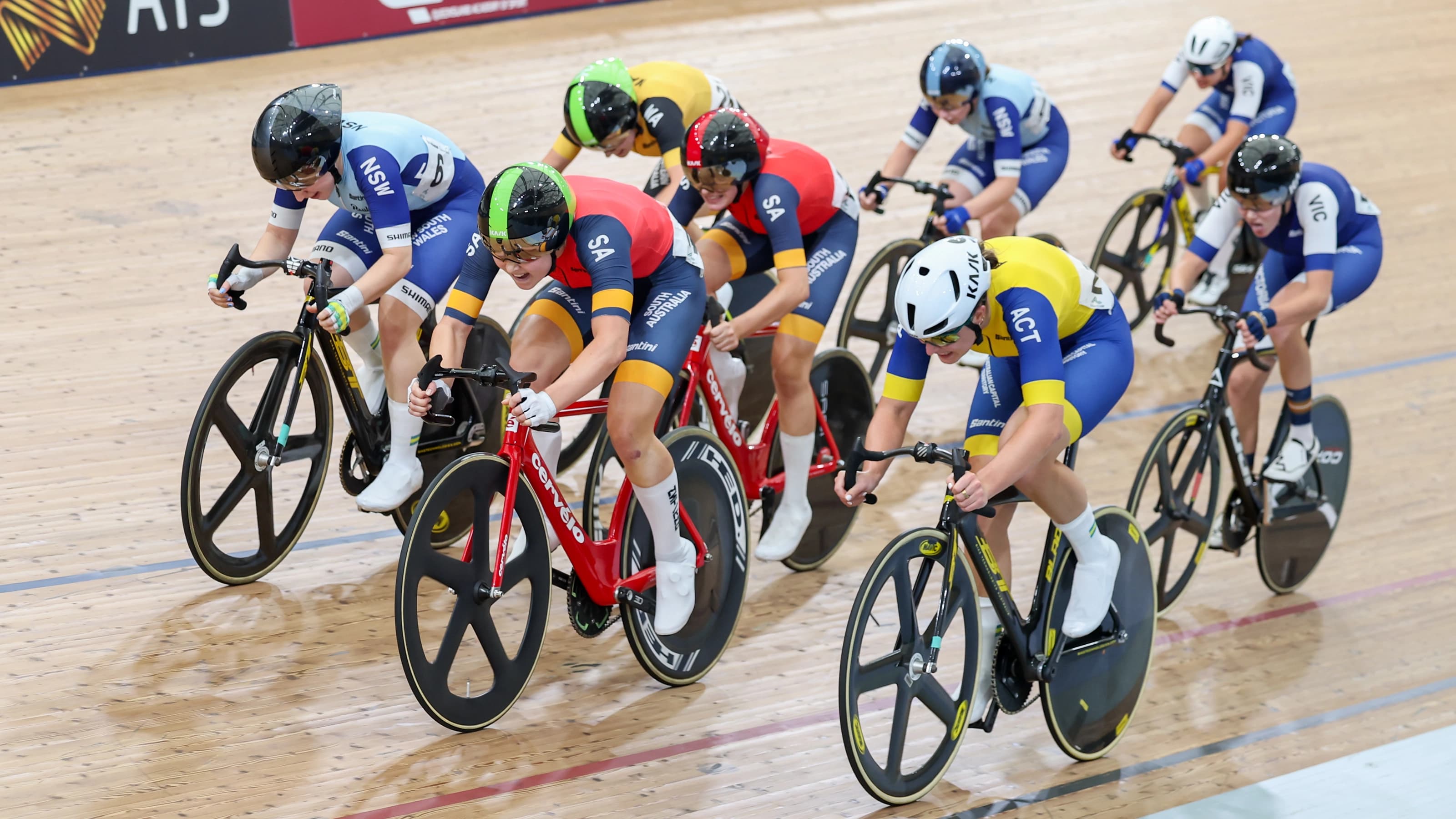 Close up shot of group of cyclists racing on Anna Meares Velodrome track