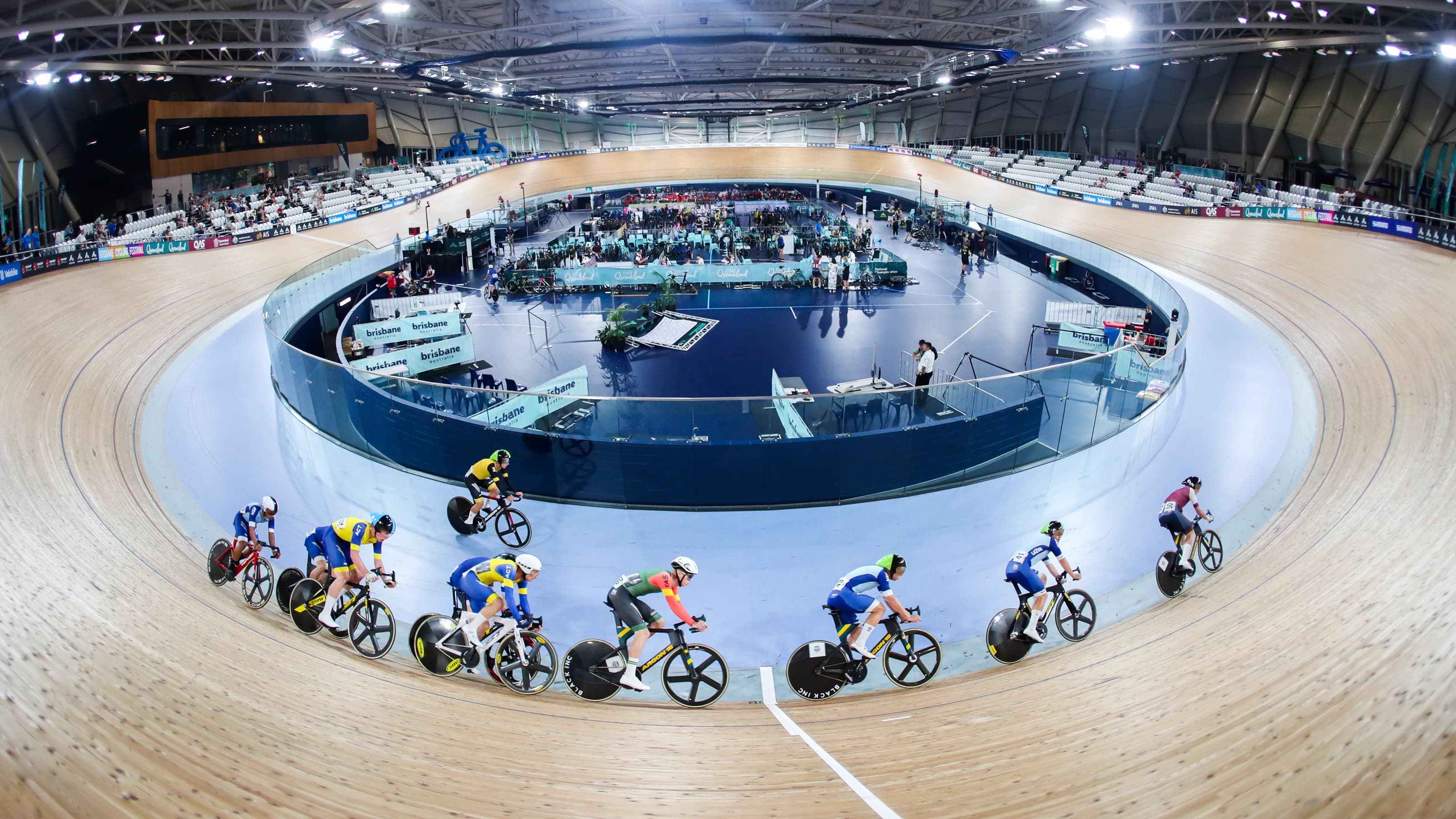 Cyclists on Anna Meares Velodrome track with audience