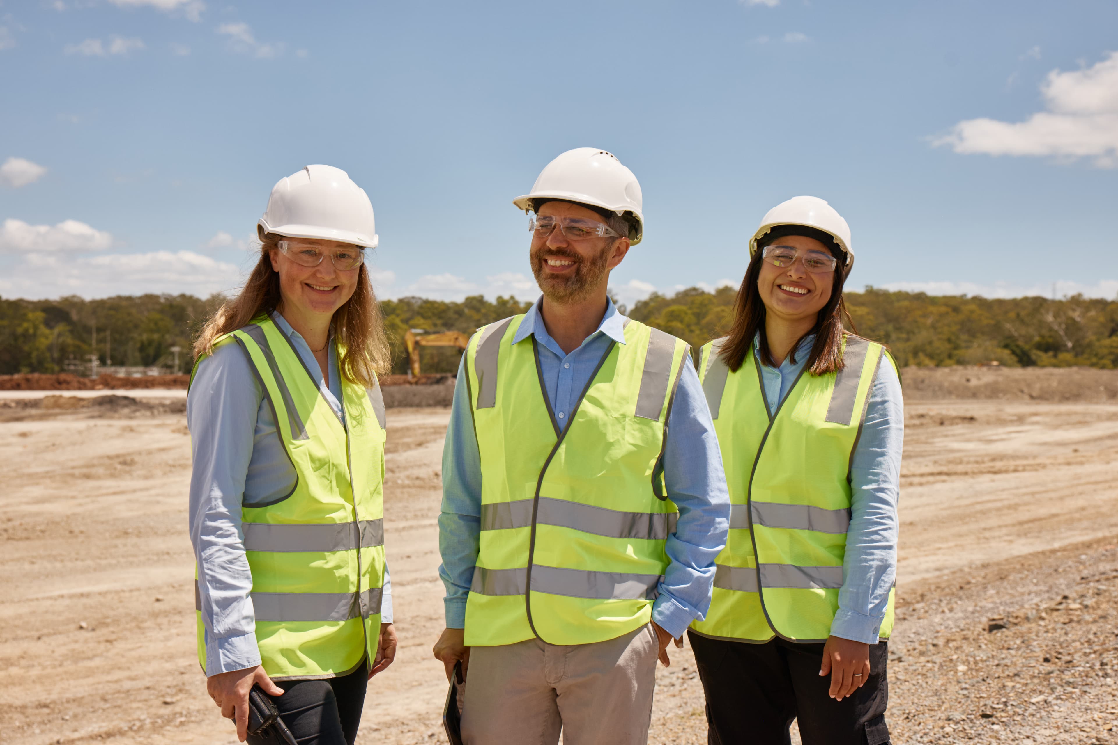 Three GIICA staff smiling at camera (Work at GIICA homepage card)