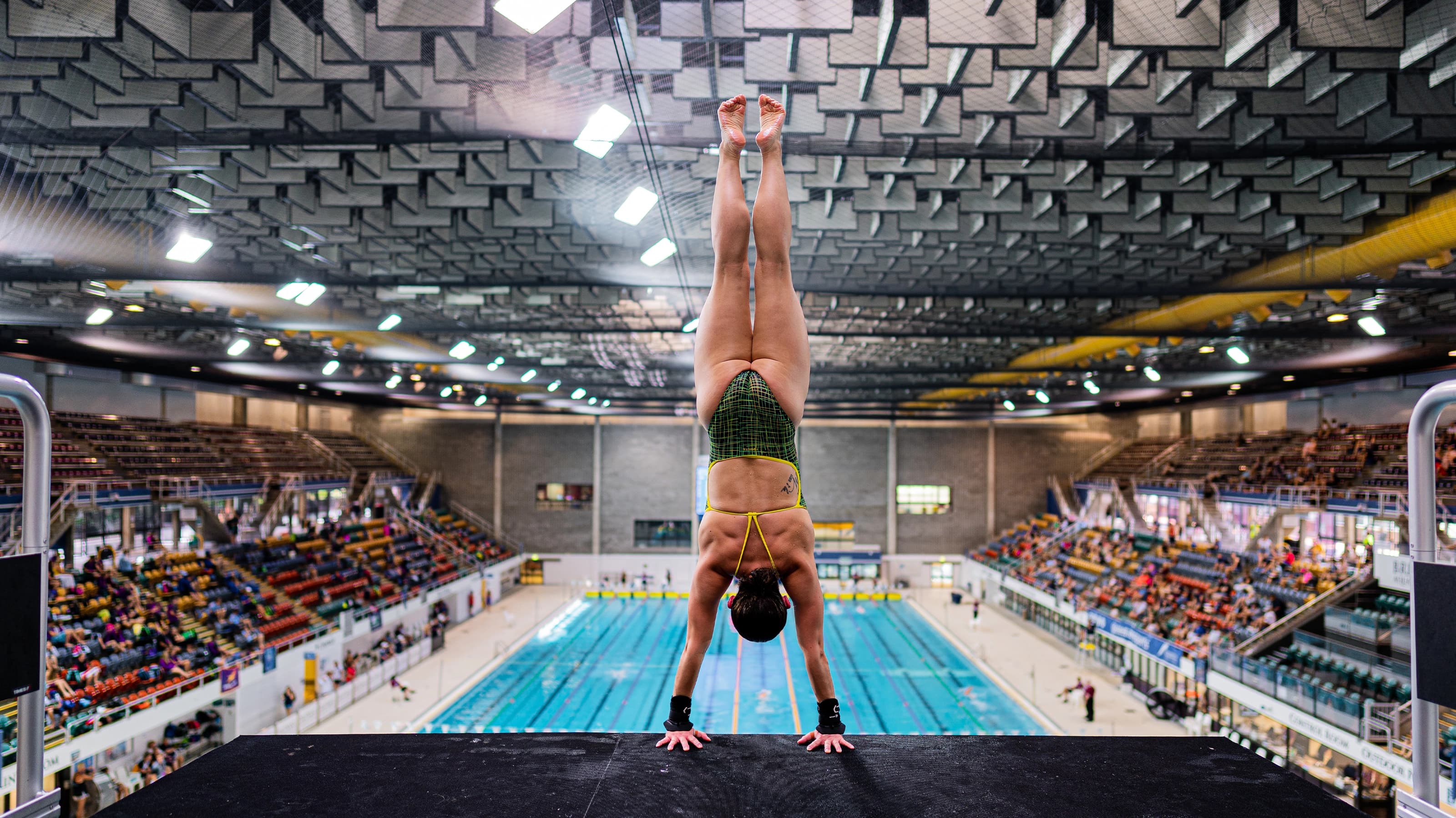 Diver in a handstand on diving platform