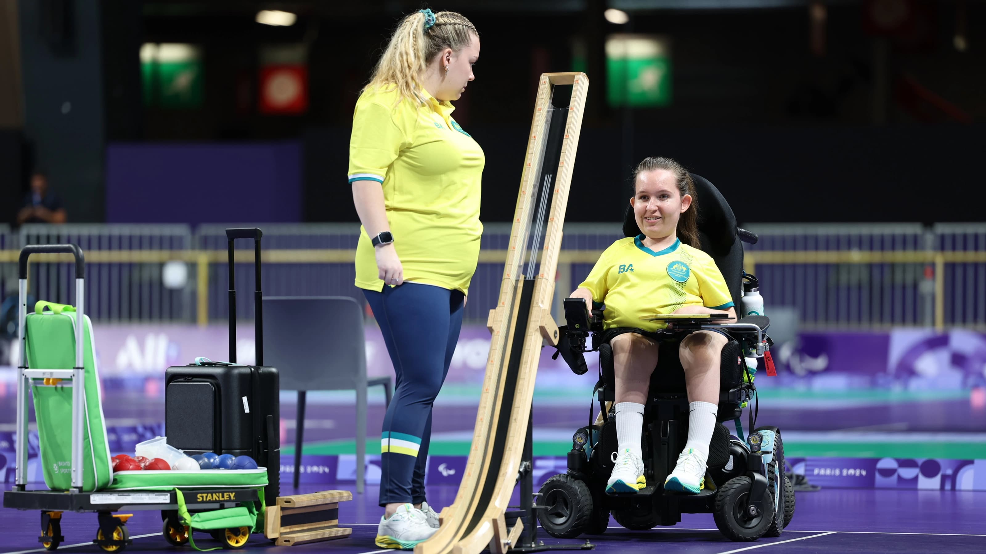 Para boccia player with team member during competition