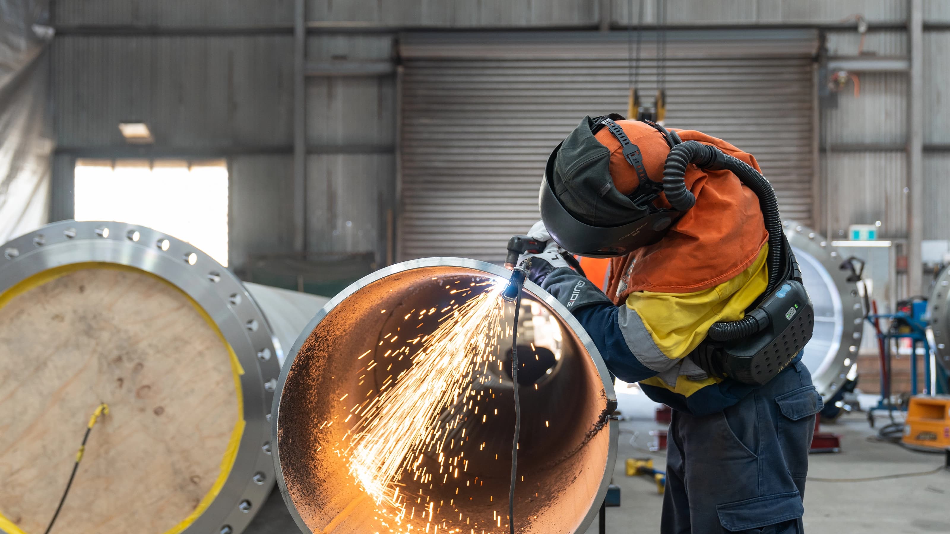 Welder working on pipe