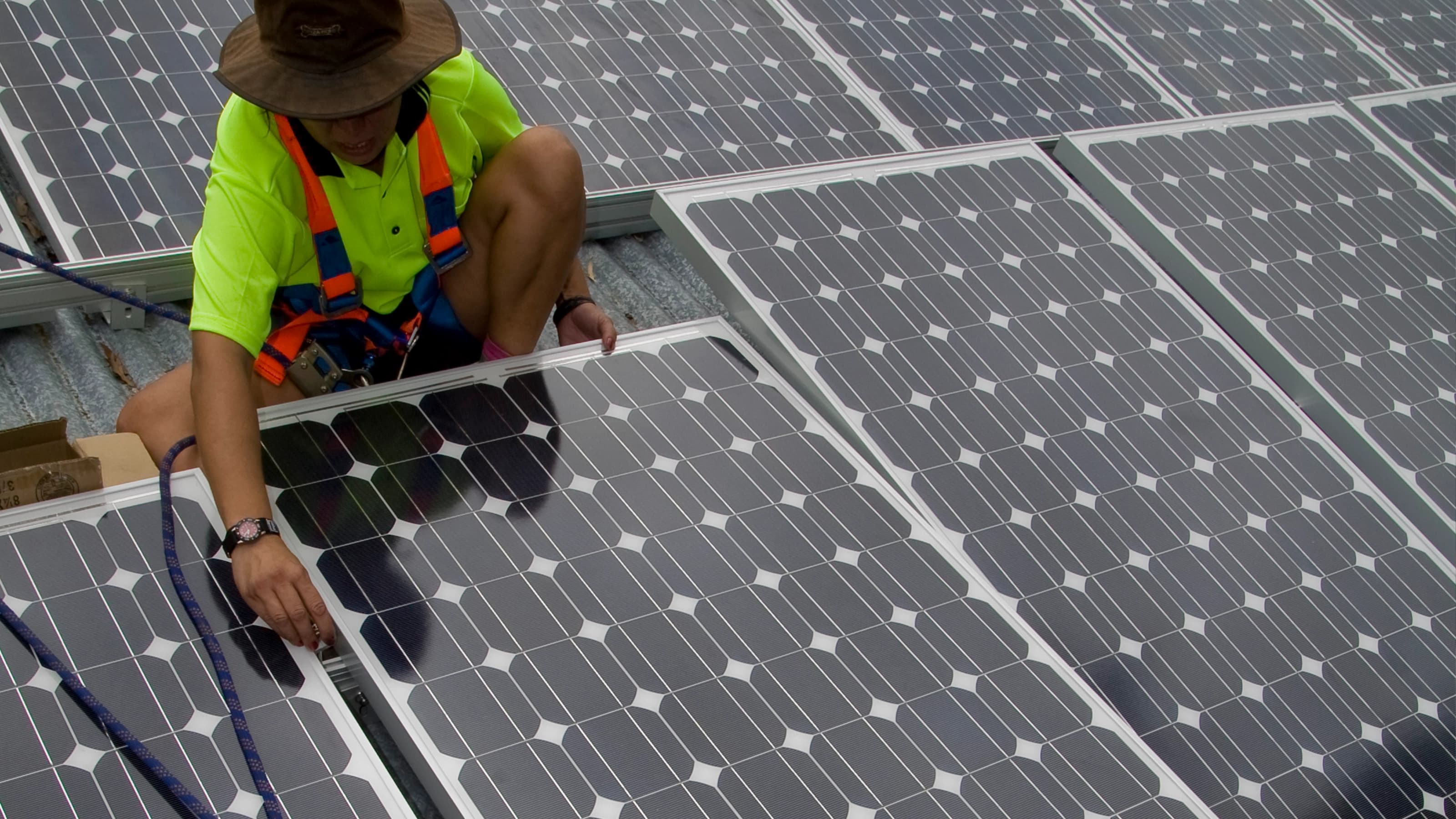 Worker performing maintenance on solar panel